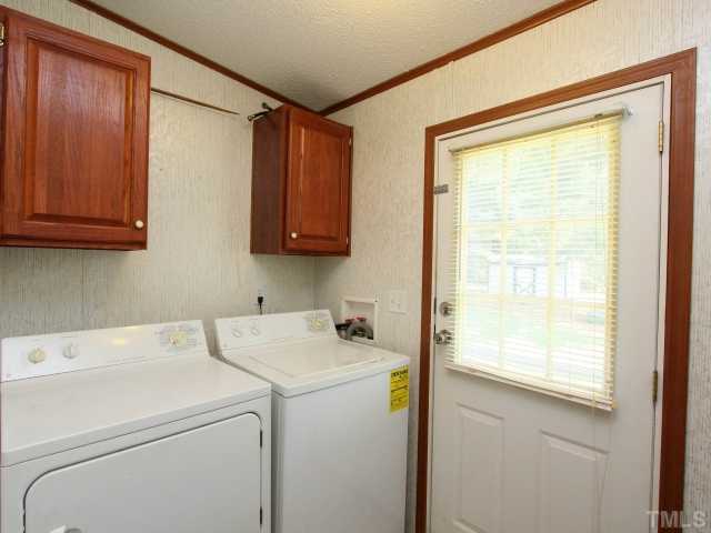 4902 West Ten Road Efland, NC 27243 - Photo 20 of 25 a view of washer and dryer with kitchen view