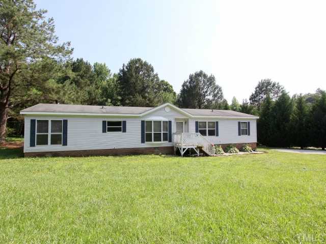 4902 West Ten Road Efland, NC 27243 - Photo 2 of 25 a front view of a house with a garden