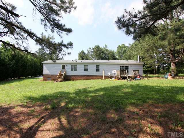4902 West Ten Road Efland, NC 27243 - Photo 22 of 25 a front view of a house with yard and green space