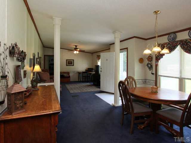 4902 West Ten Road Efland, NC 27243 - Photo 6 of 25 a view of a dining room with furniture and wooden floor