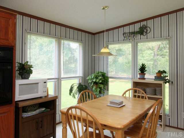 4902 West Ten Road Efland, NC 27243 - Photo 10 of 25 a view of a dining room with furniture window and outside view