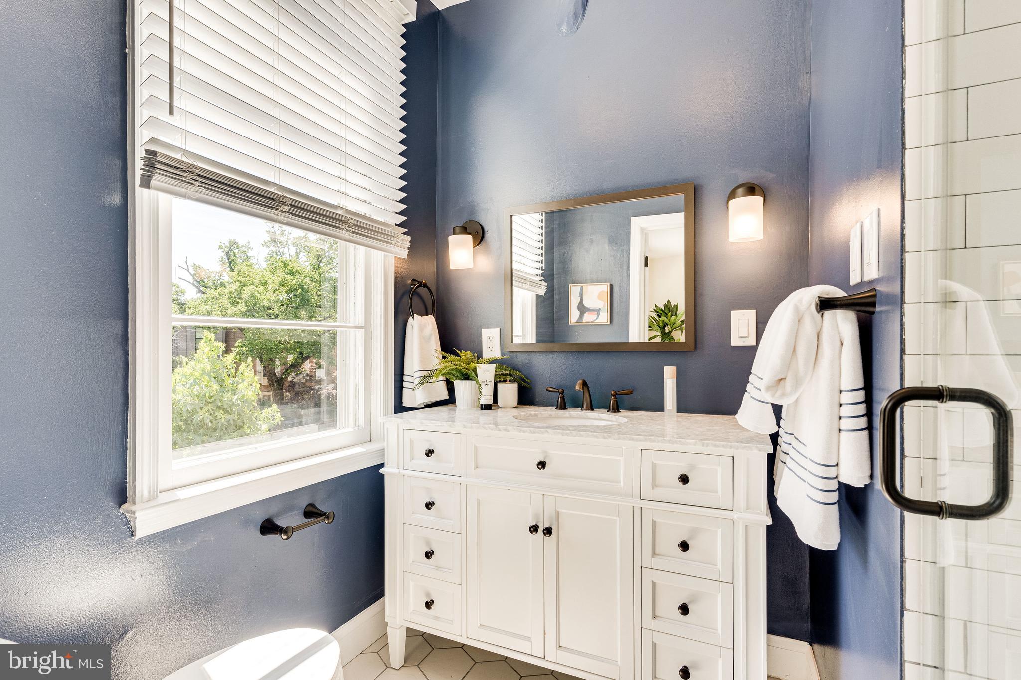 329 11th Street Southeast Washington, DC 20003 - Photo 22 of 49 a bathroom with a granite countertop sink vanity mirror next to a window