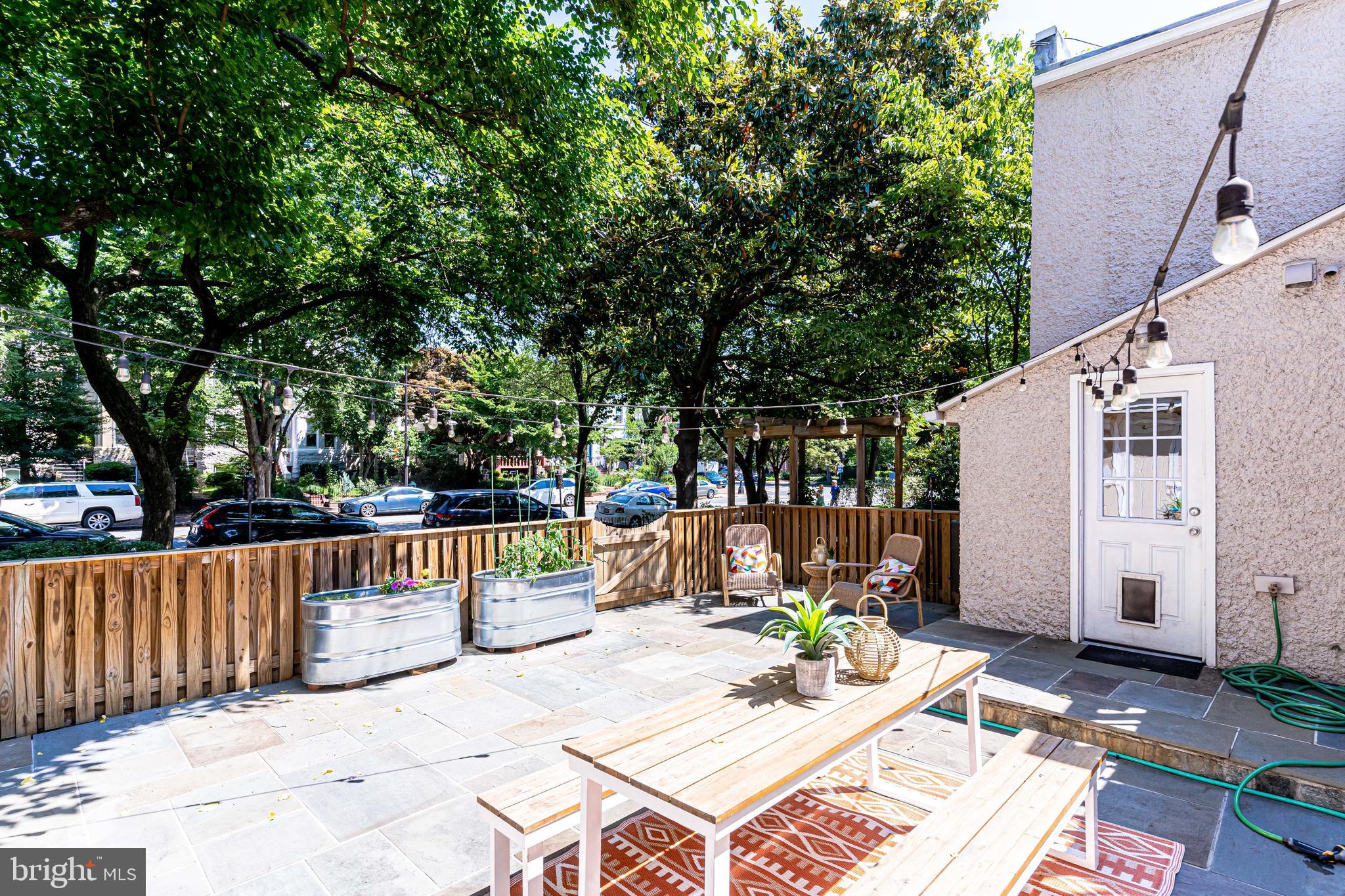 329 11th Street Southeast Washington, DC 20003 - Photo 31 of 49 a view of a patio with table and chairs and potted plants