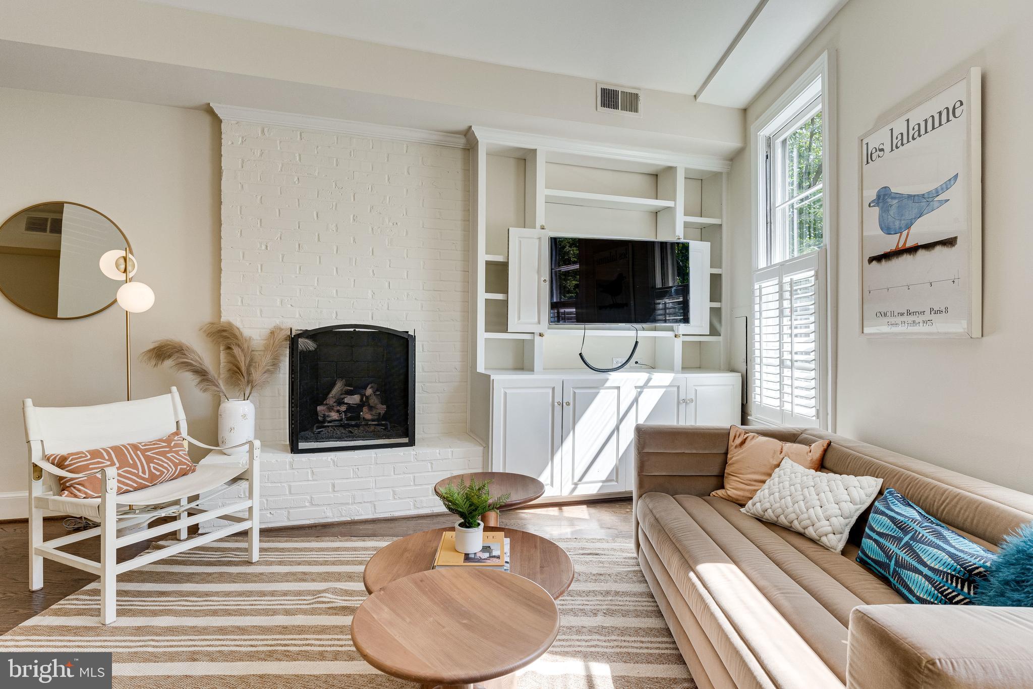 329 11th Street Southeast Washington, DC 20003 - Photo 4 of 49 a living room with furniture a flat screen tv and a fireplace