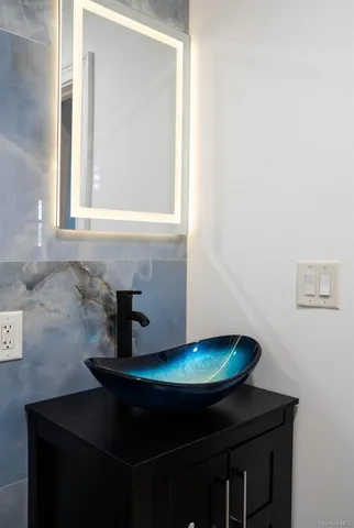 a bathroom with a sink and a mirror