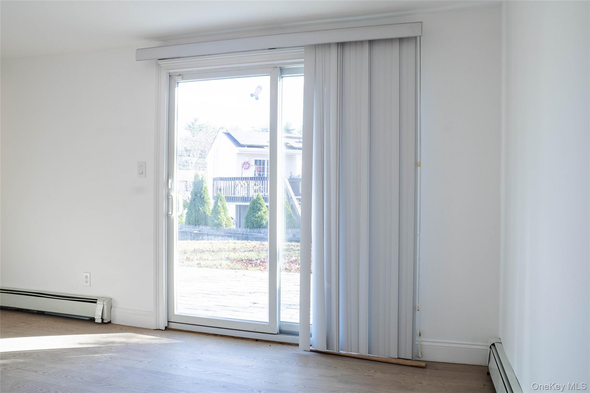 58 Hauppauge Road Hauppauge, NY 11788 - Photo 24 of 34 Doorway with a baseboard radiator and wood finished floors