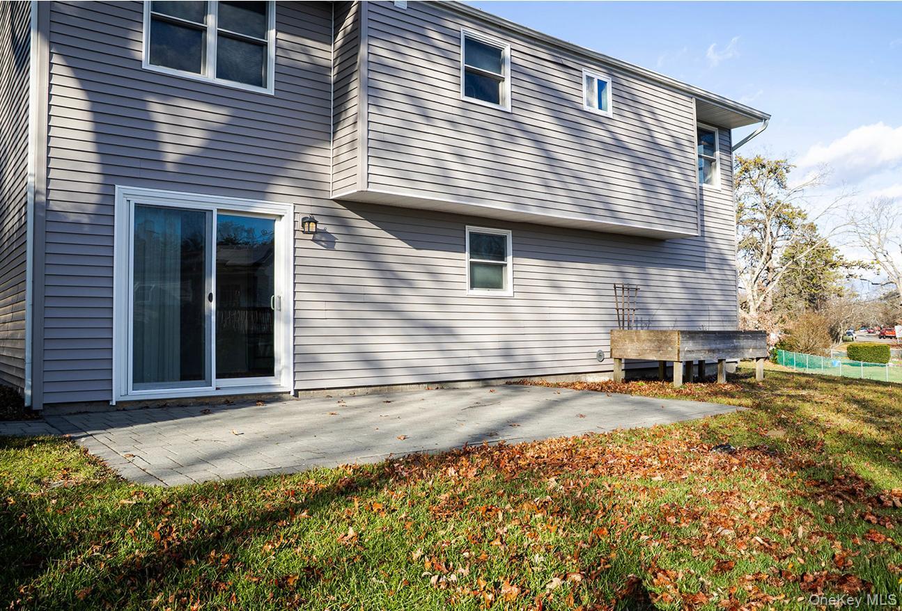 58 Hauppauge Road Hauppauge, NY 11788 - Photo 31 of 34 Back of property with a patio and a lawn