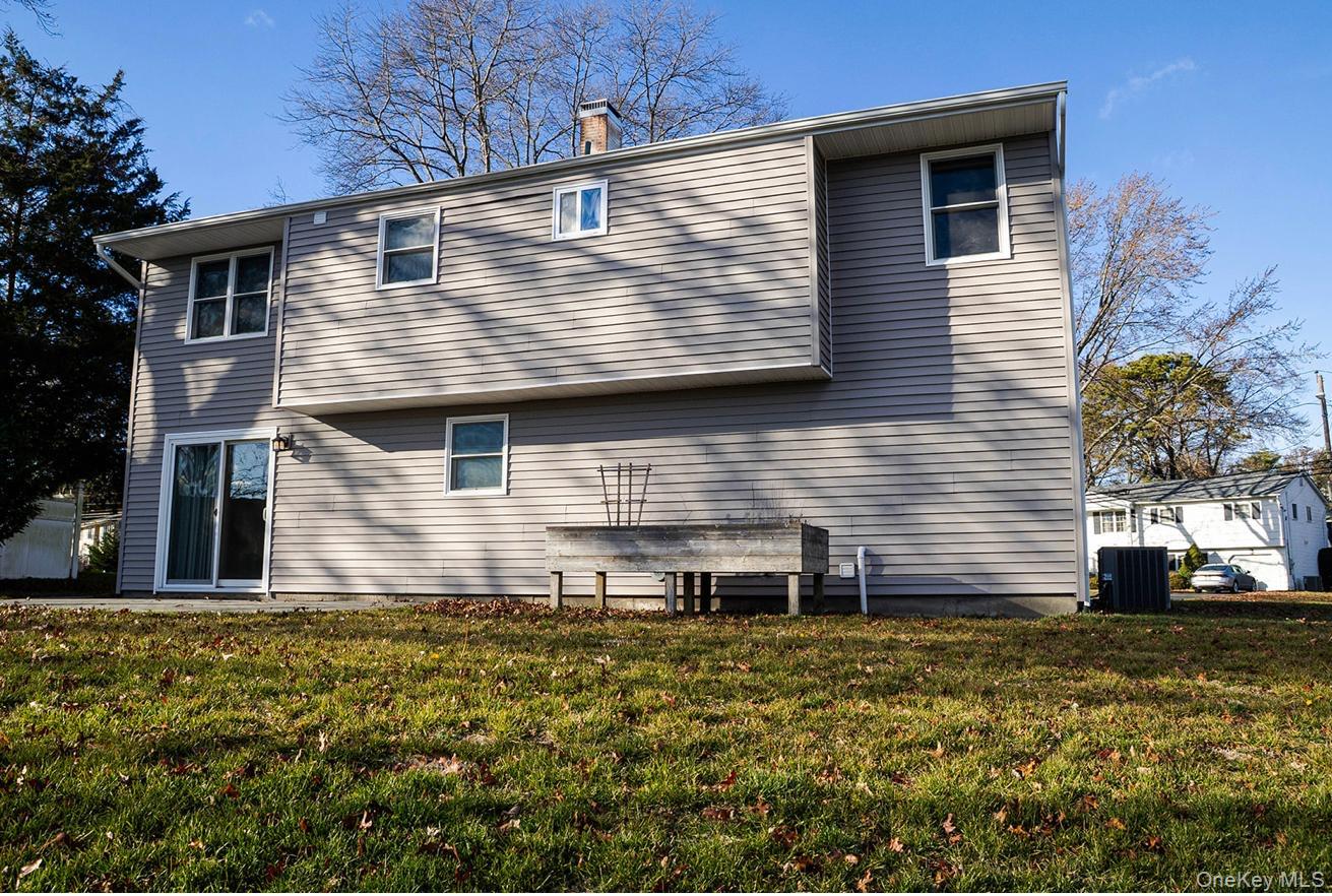 58 Hauppauge Road Hauppauge, NY 11788 - Photo 33 of 34 Back of property with a lawn and a chimney