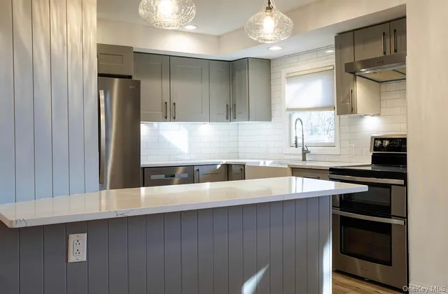 a kitchen with a sink a stove and cabinets