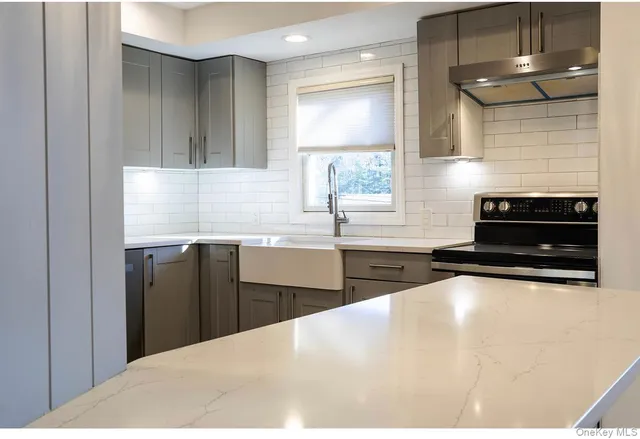 a kitchen with a sink a stove and cabinets