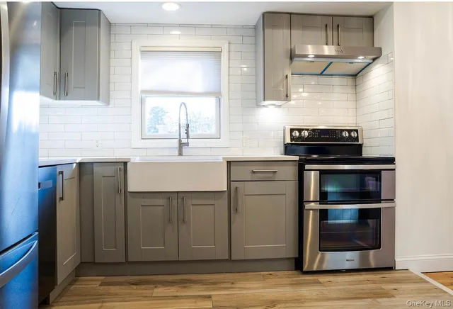 a kitchen with a sink cabinets and stainless steel appliances