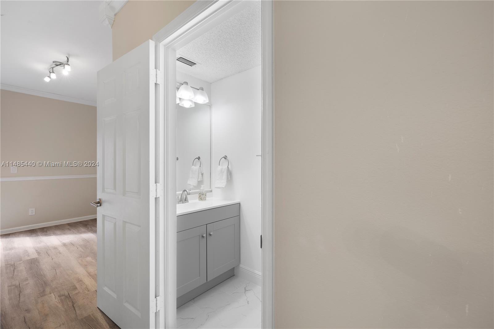 16225 Emerald Cove Road, Unit 16225 Weston, FL 33331 - Photo 11 of 26 a bathroom with a granite countertop sink and a mirror