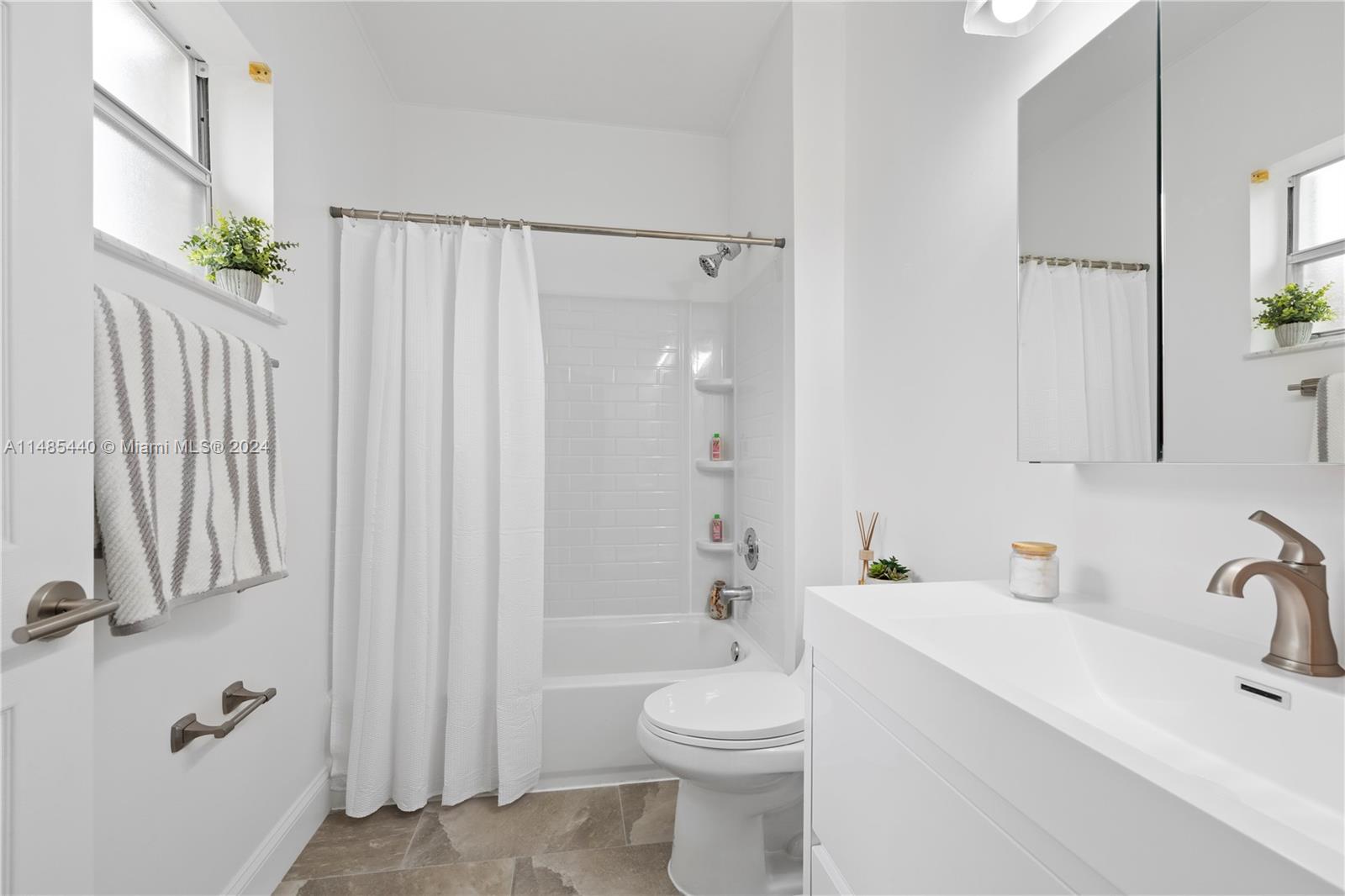 16225 Emerald Cove Road, Unit 16225 Weston, FL 33331 - Photo 16 of 26 a bathroom with a sink a toilet and shower
