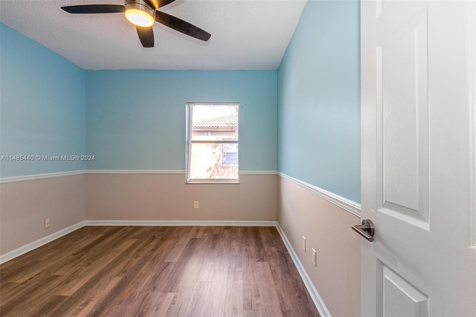 16225 Emerald Cove Road, Unit 16225 Weston, FL 33331 - Photo 18 of 26 wooden floor in an empty room with a window