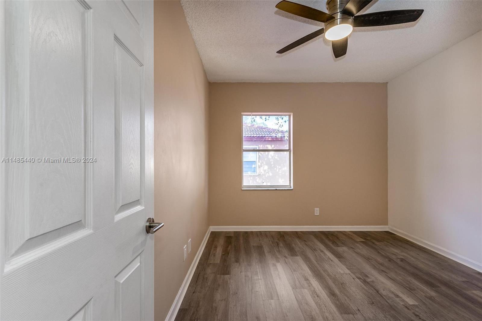 16225 Emerald Cove Road, Unit 16225 Weston, FL 33331 - Photo 19 of 26 an empty room with a window and a ceiling fan