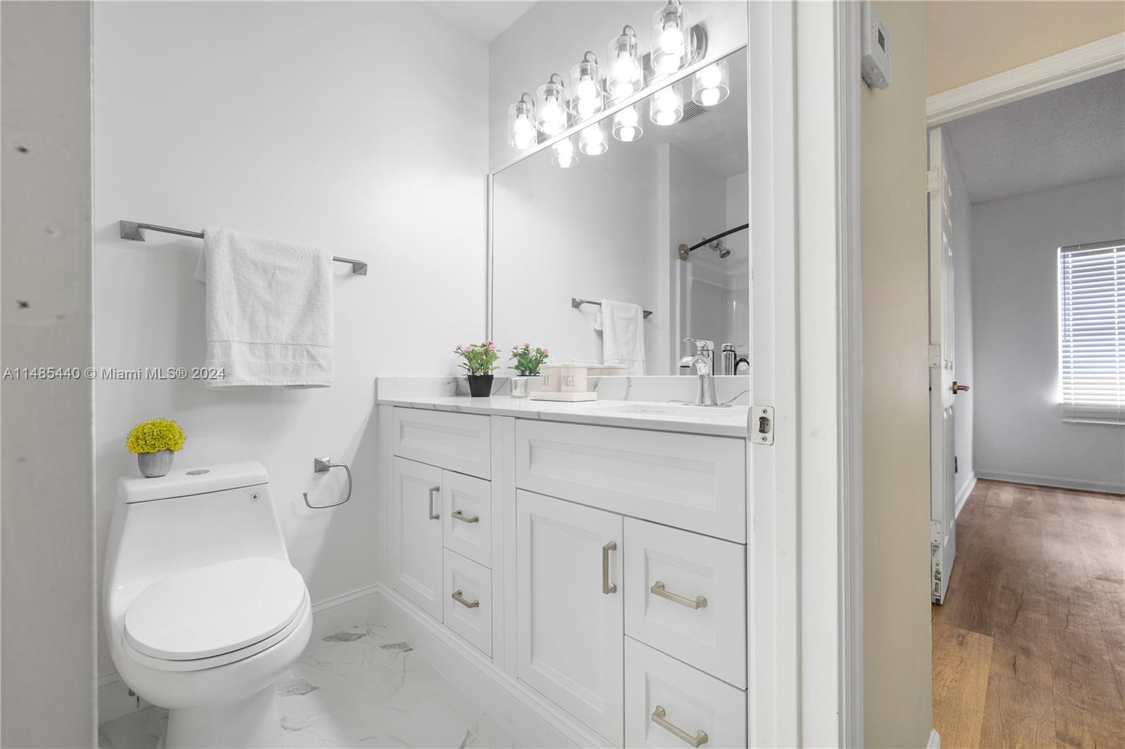 16225 Emerald Cove Road, Unit 16225 Weston, FL 33331 - Photo 21 of 26 a bathroom with a sink a toilet and a mirror