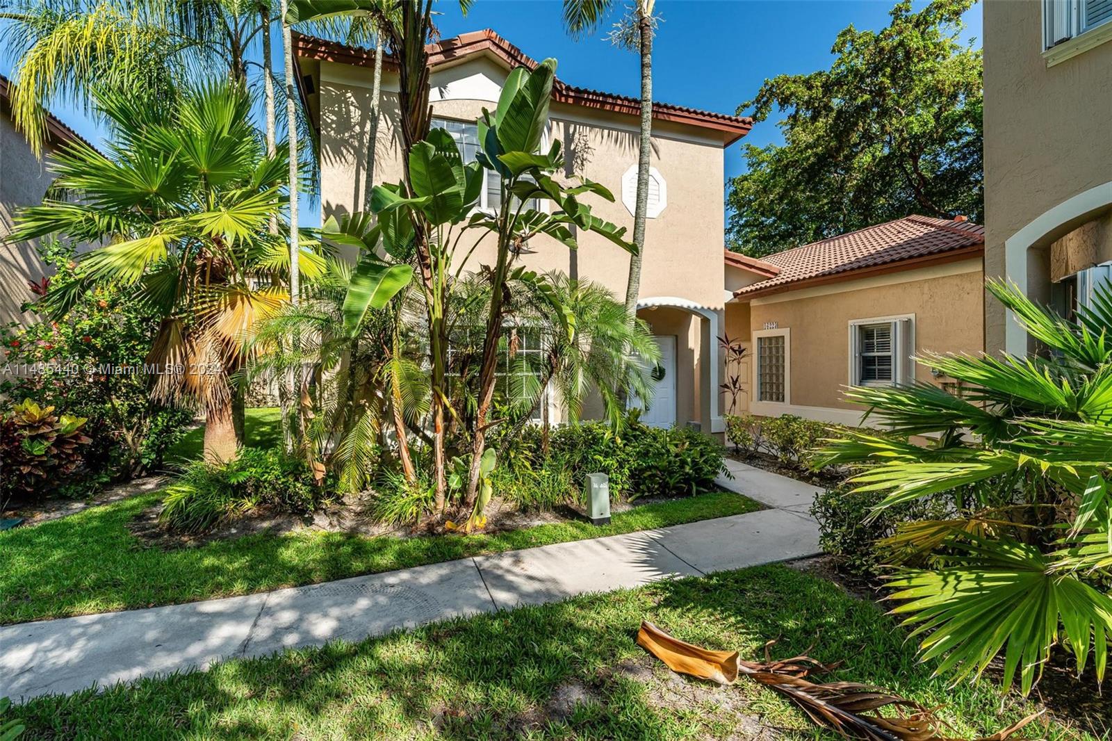 16225 Emerald Cove Road, Unit 16225 Weston, FL 33331 - Photo 24 of 26 a backyard of a house with plants and garden