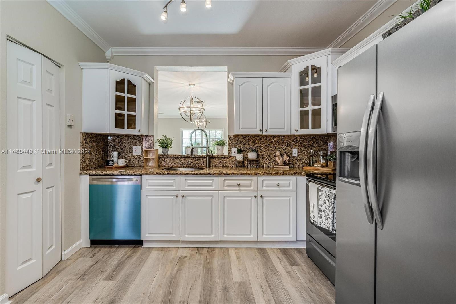 16225 Emerald Cove Road, Unit 16225 Weston, FL 33331 - Photo 6 of 26 a kitchen with stainless steel appliances a refrigerator sink and microwave