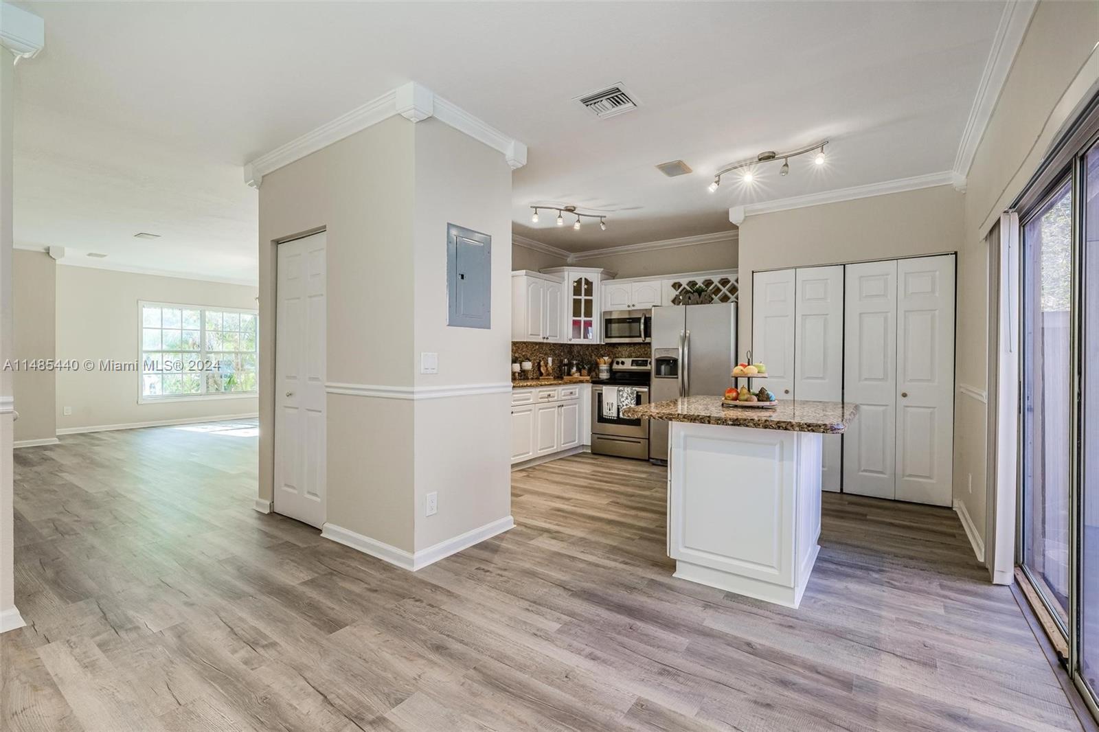 16225 Emerald Cove Road, Unit 16225 Weston, FL 33331 - Photo 8 of 26 a kitchen with kitchen island and stainless steel appliances