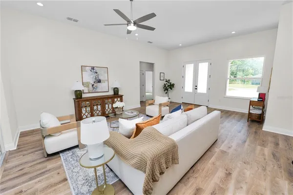 a living room with furniture and a potted plant