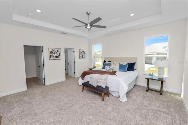 a bedroom with a bed and a chandelier