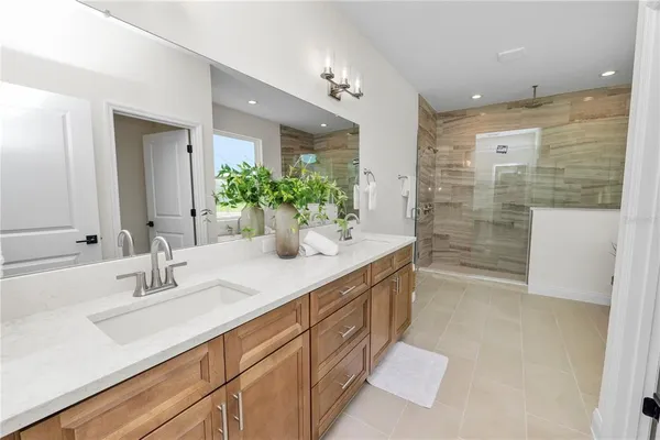 a bathroom with a white tub shower and sink