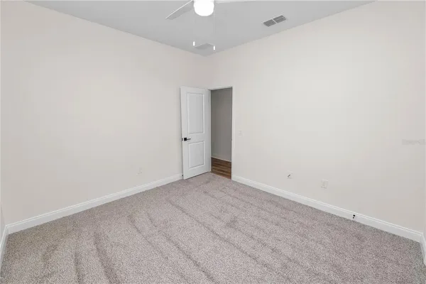 a view of an empty room with glass door