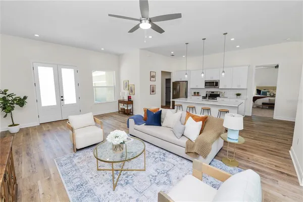 a living room with furniture and a wooden floor