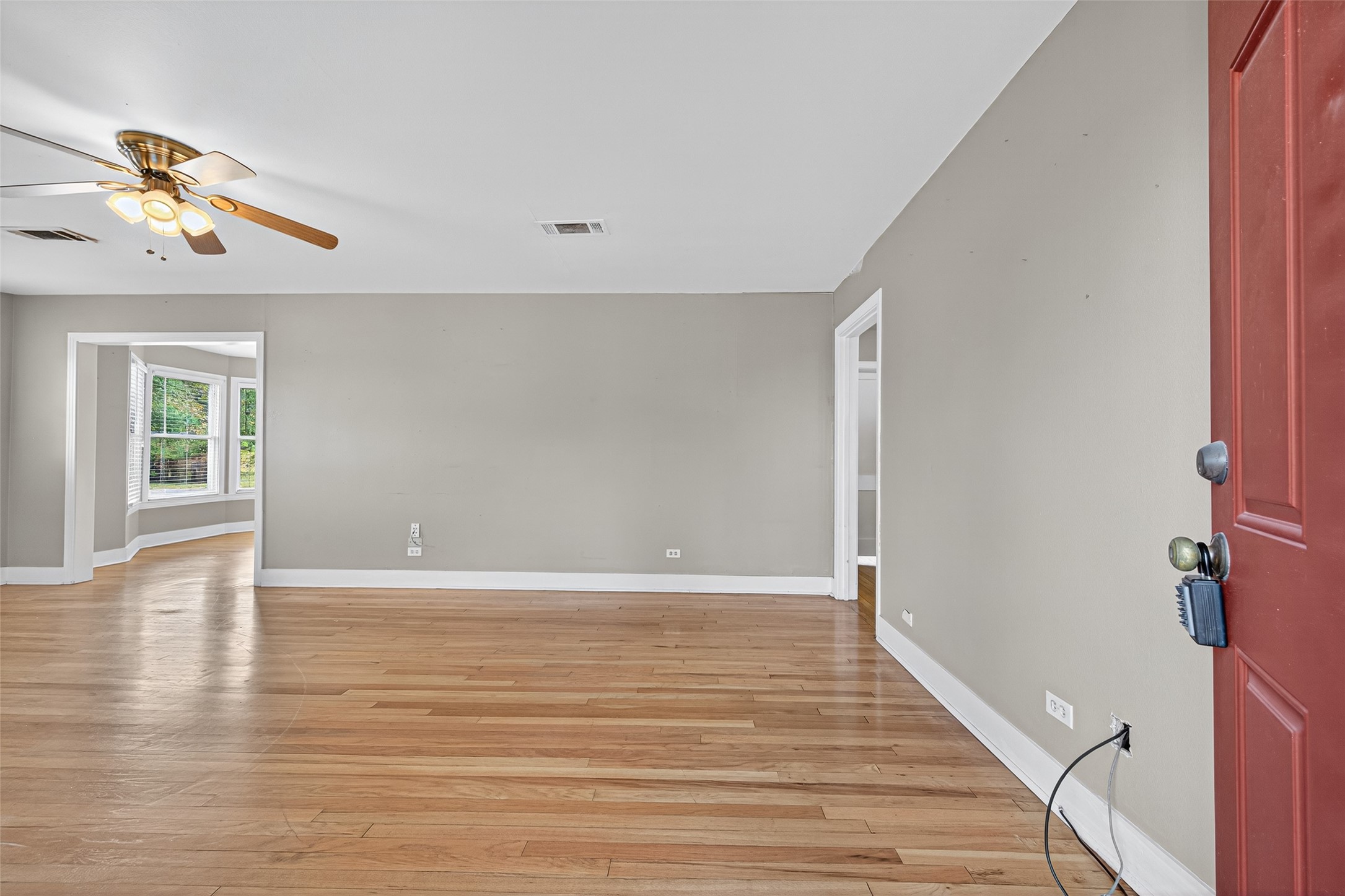 1020 Houston Street Conroe, TX 77301 - Photo 12 of 43 a view of an empty room with window and wooden floor