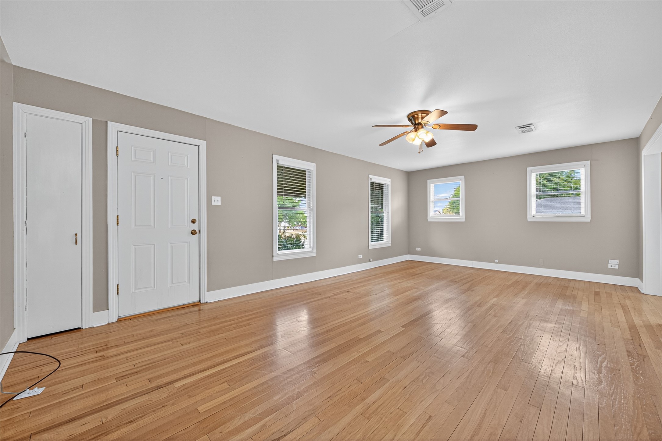 1020 Houston Street Conroe, TX 77301 - Photo 14 of 43 a view of an empty room with a window and wooden floor