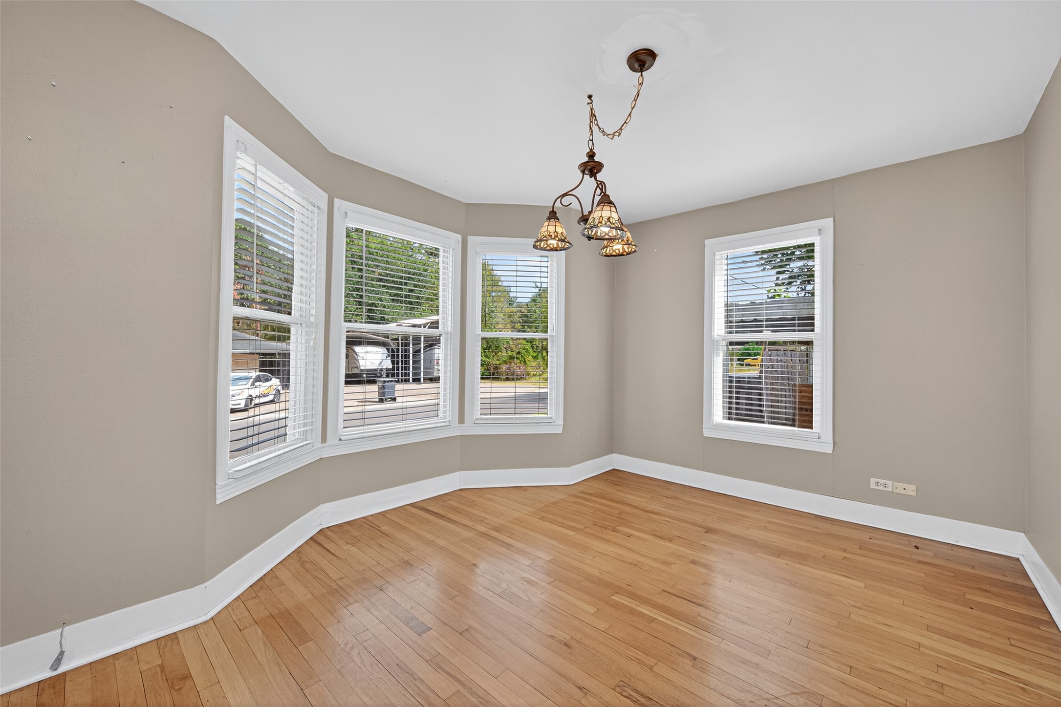 1020 Houston Street Conroe, TX 77301 - Photo 17 of 43 a view of an empty room with a window and wooden floor