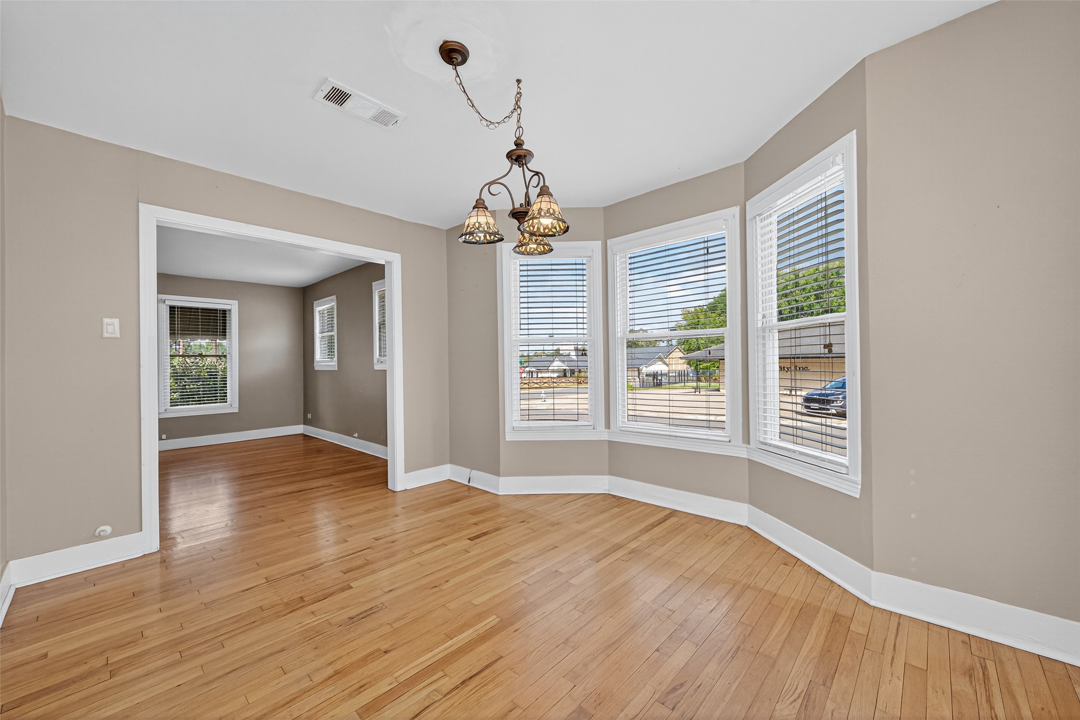 1020 Houston Street Conroe, TX 77301 - Photo 18 of 43 a view of an empty room with wooden floor and a window