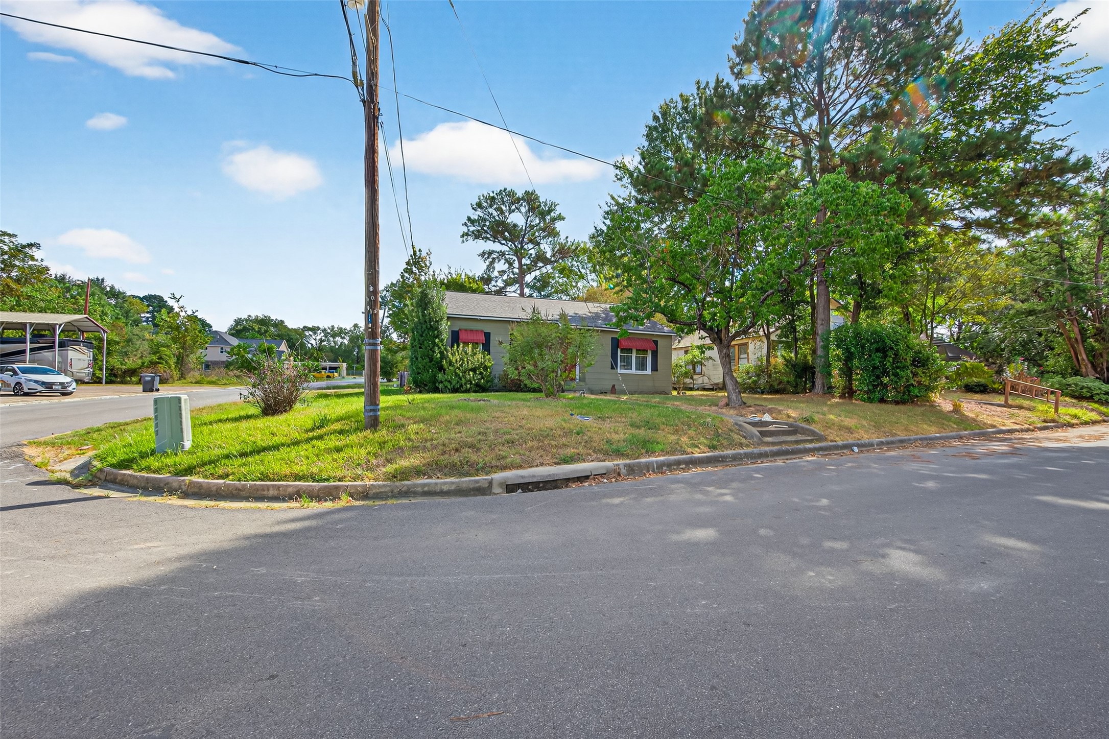 1020 Houston Street Conroe, TX 77301 - Photo 2 of 43 a view of a house with a big yard and large trees
