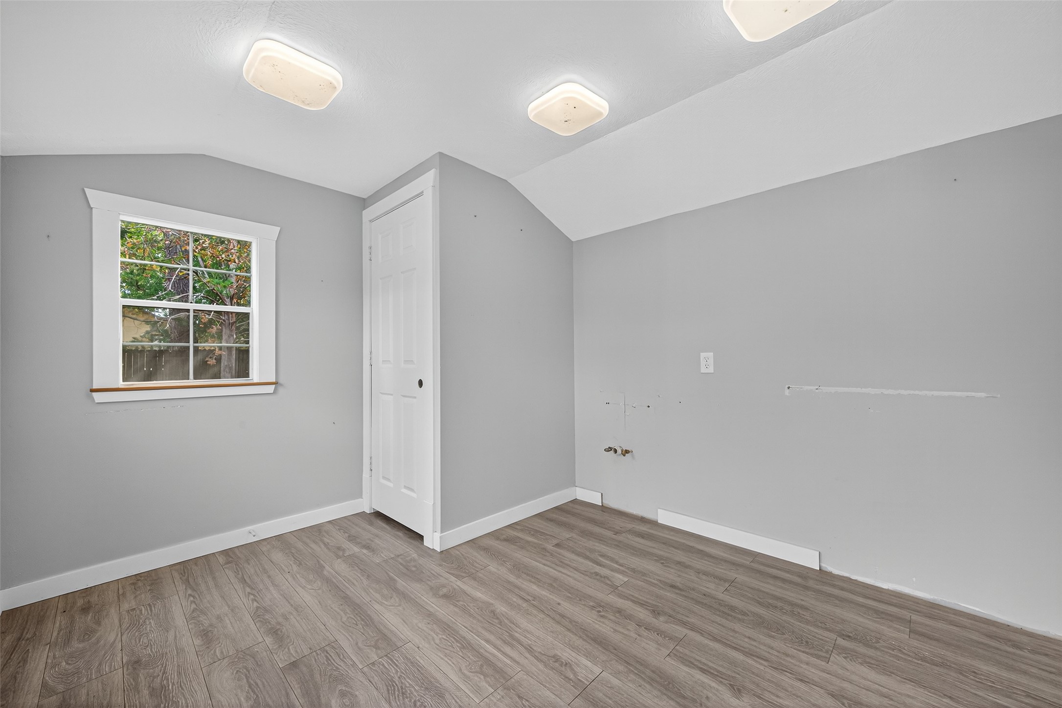 1020 Houston Street Conroe, TX 77301 - Photo 25 of 43 an empty room with wooden floor and windows