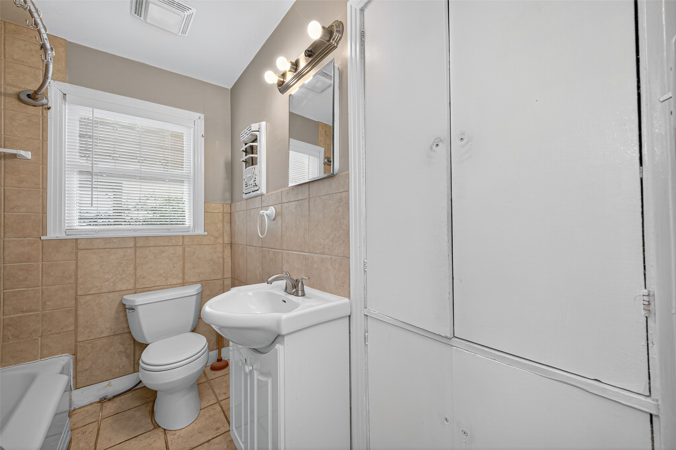 1020 Houston Street Conroe, TX 77301 - Photo 30 of 43 a bathroom with a toilet sink and mirror