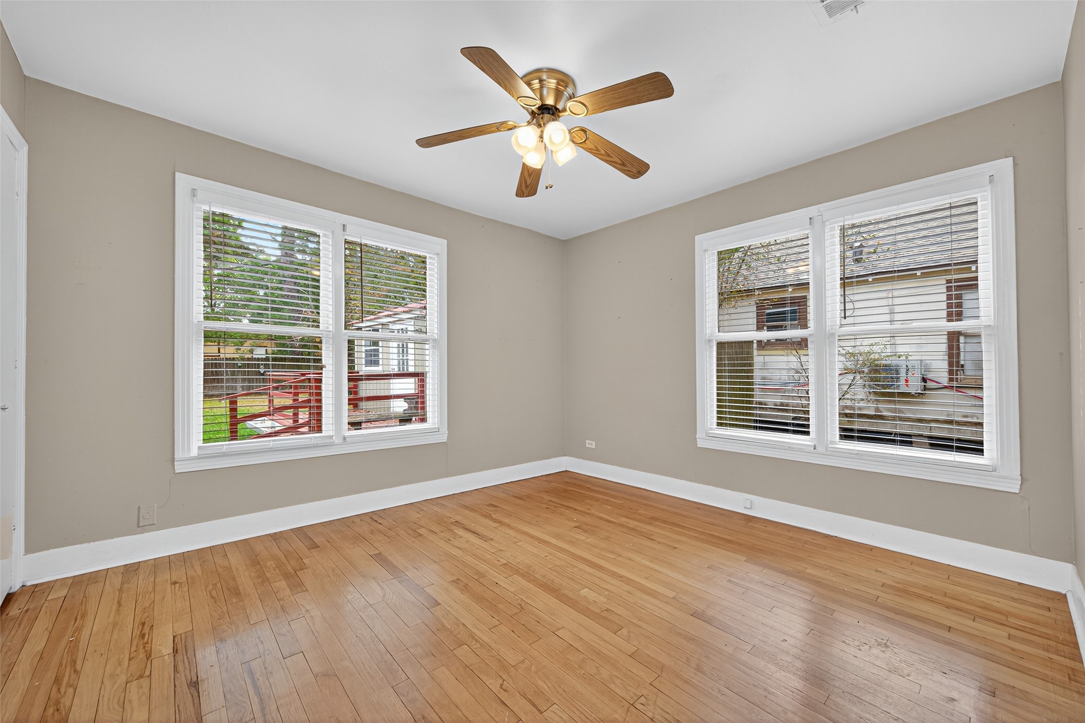 1020 Houston Street Conroe, TX 77301 - Photo 34 of 43 a view of an empty room with wooden floor and a window