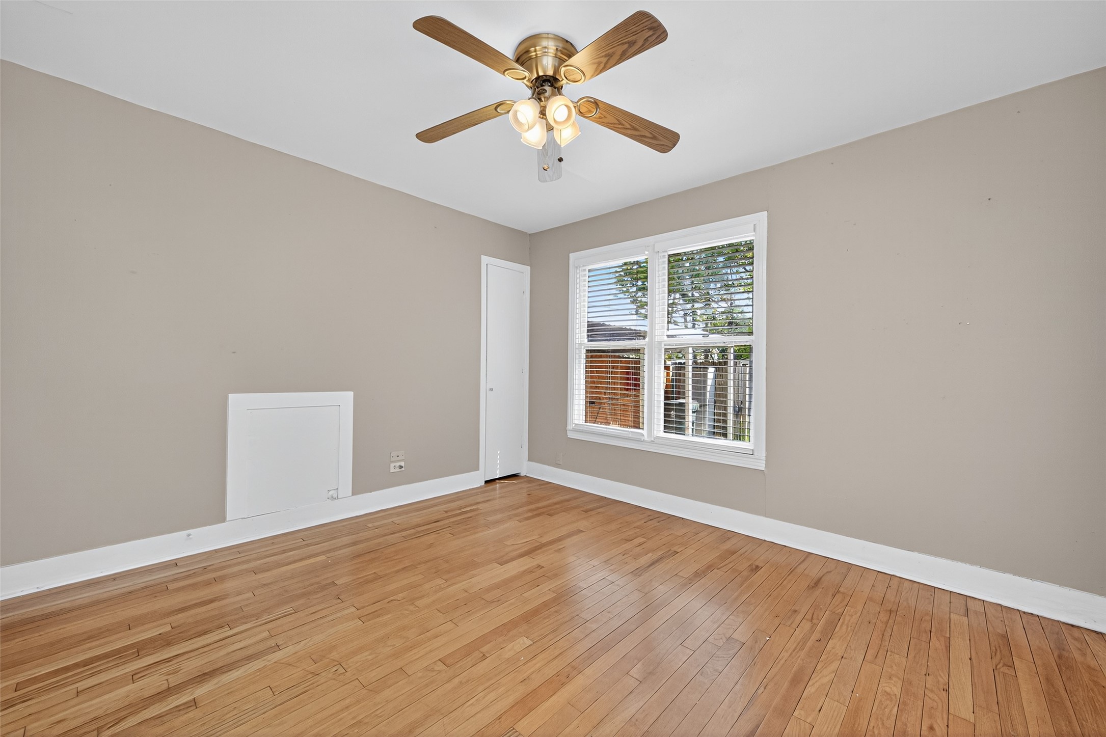 1020 Houston Street Conroe, TX 77301 - Photo 36 of 43 a view of an empty room with window and wooden floor