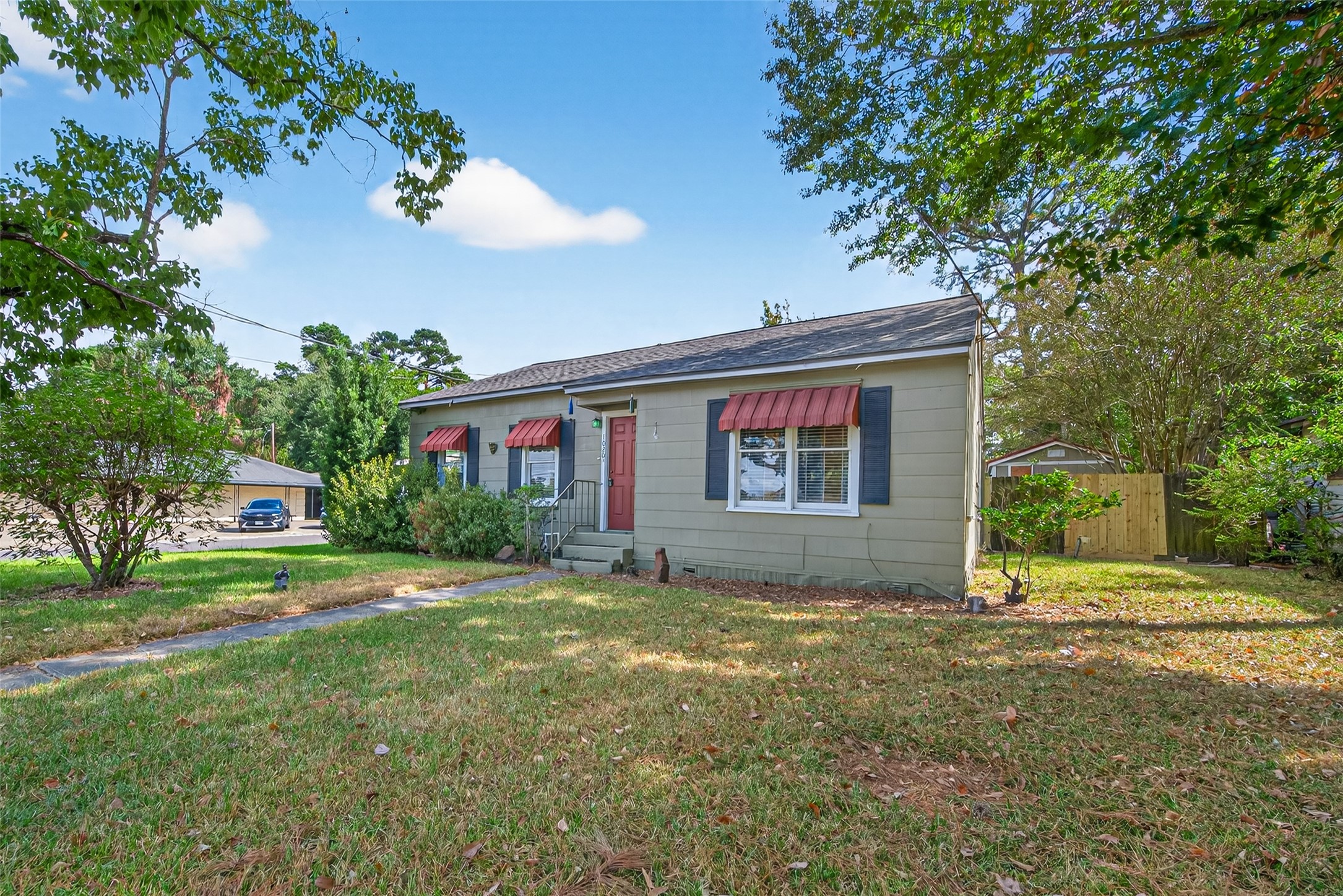 1020 Houston Street Conroe, TX 77301 - Photo 6 of 43 a view of a house with a yard and garage