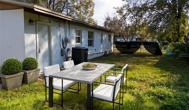 a view of backyard of house with seating space