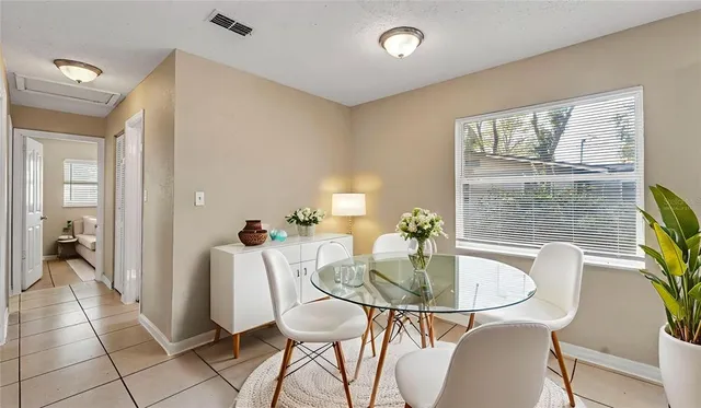a dining room with furniture and window