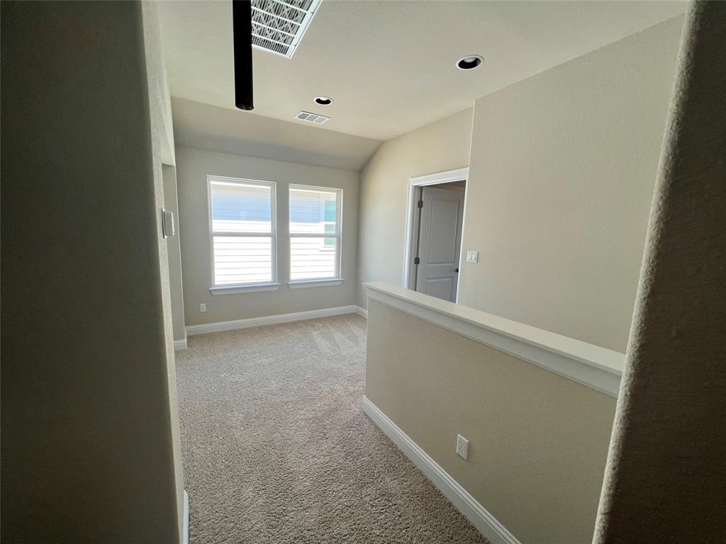 128 Free Stone Drive Georgetown, TX 78628 - Photo 18 of 29 Carpeted loft area with two windows featuring horizontal blinds