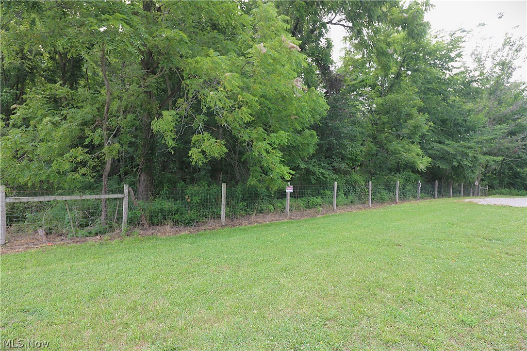 5236 Zenobia Road Wakeman, OH 44889 - Photo 30 of 31 Expansive grassy area bordered by a wire fence and mature trees
