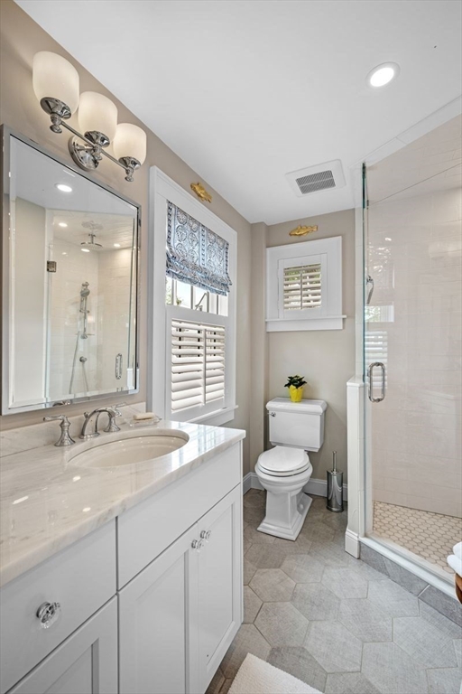 31 Franklin Street Marblehead, MA 01945 - Photo 21 of 35 a bathroom with a toilet sink and mirror