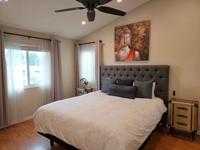 a bedroom with a bed and wooden floor