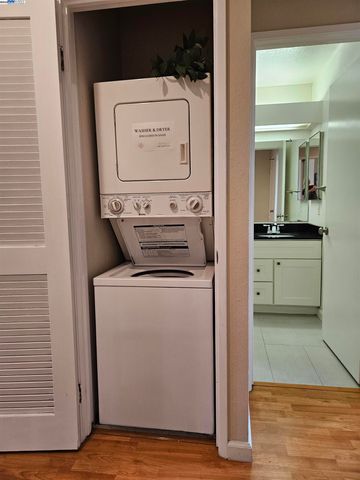 a view of washer and dryer with a kitchen view