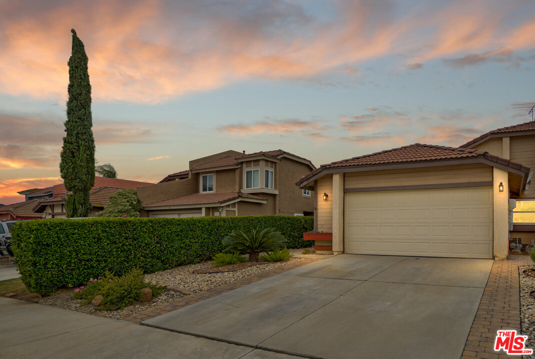 6397 Pine Falls Trail Riverside, CA 92509 - Photo 1 of 14 a front view of a house with a yard and garage