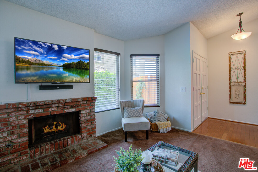 6397 Pine Falls Trail Riverside, CA 92509 - Photo 4 of 14 a living room with furniture a rug and a fireplace