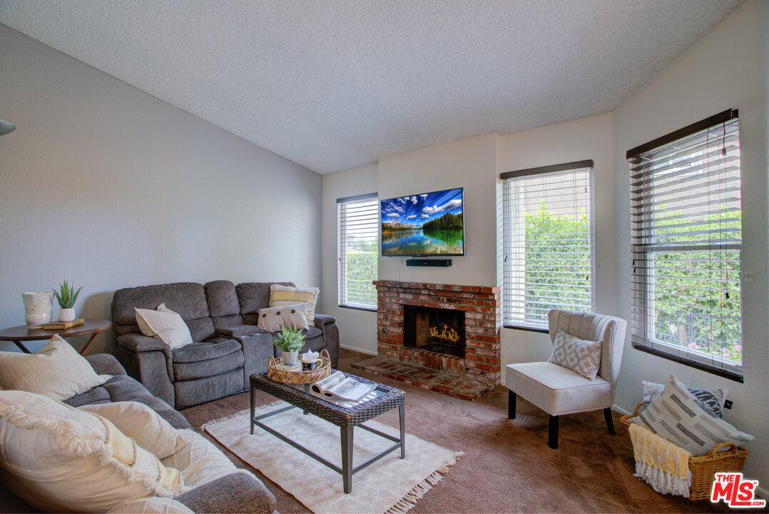 6397 Pine Falls Trail Riverside, CA 92509 - Photo 5 of 14 a living room with furniture a window and a fireplace