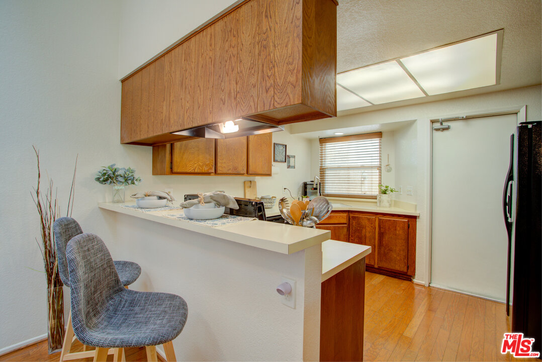 6397 Pine Falls Trail Riverside, CA 92509 - Photo 7 of 14 a kitchen with stainless steel appliances a sink stove and refrigerator