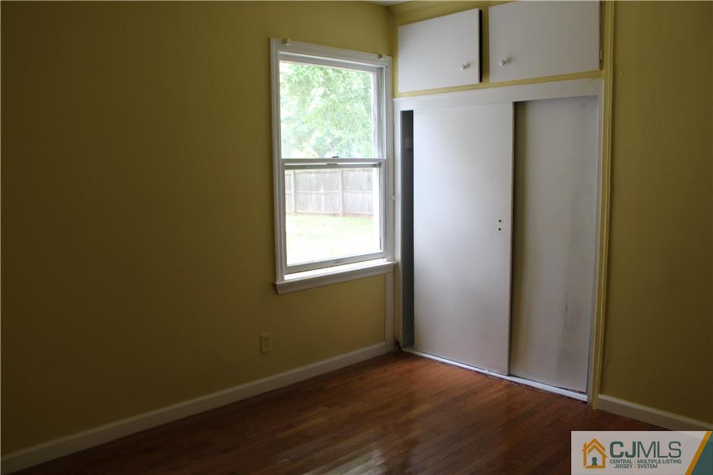14 Kenmore Road Edison, NJ 08817 - Photo 12 of 21 a view of an empty room with wooden floor and a window